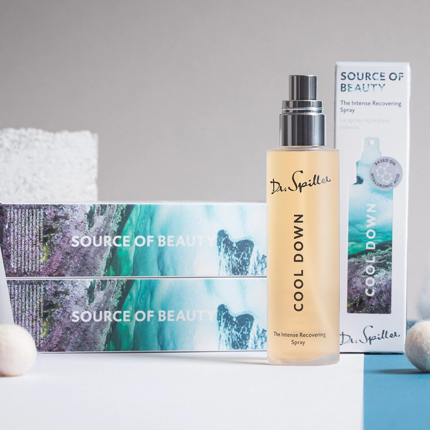 The Intense Recovering Spray spray bottle with 3 packages in the background