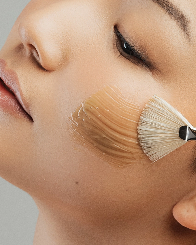 Facial care application on the cheek with the brush