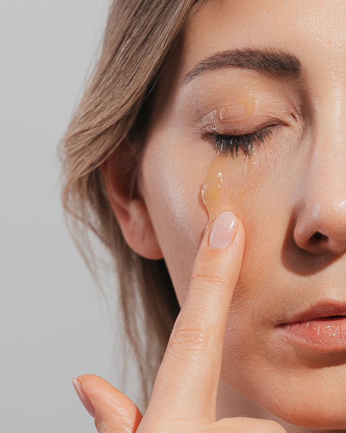 Woman applies organic PreCleanser to her face