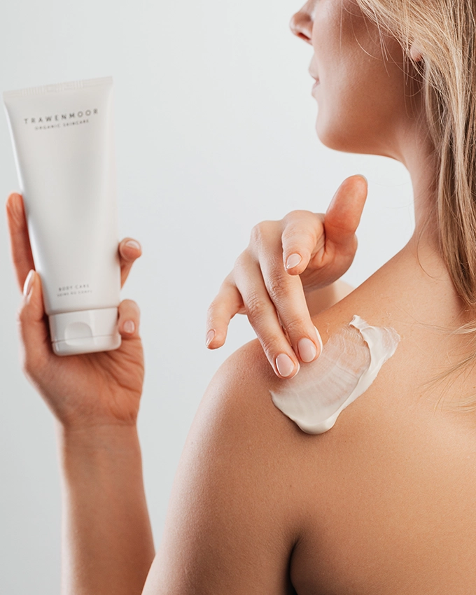 Woman applies Trawenmoor Body Cream to her shoulder
