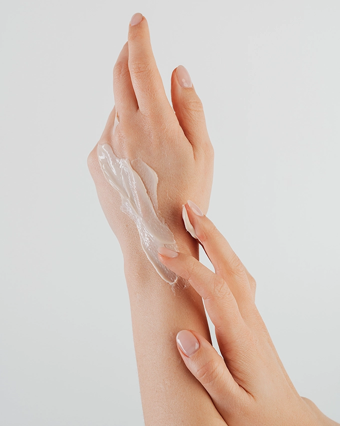 Woman cares for her hands with Hand Cream