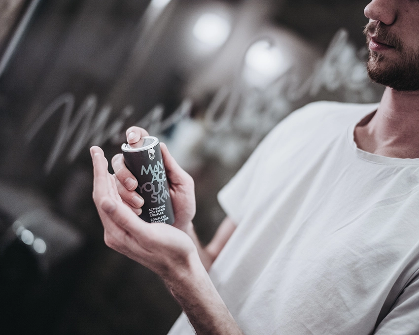 Man holding Manage Your Skin pump dispenser in his hand