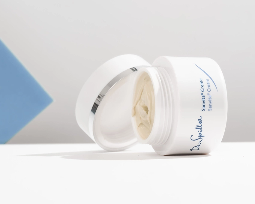 Open Sanvita cream jar lying on its side