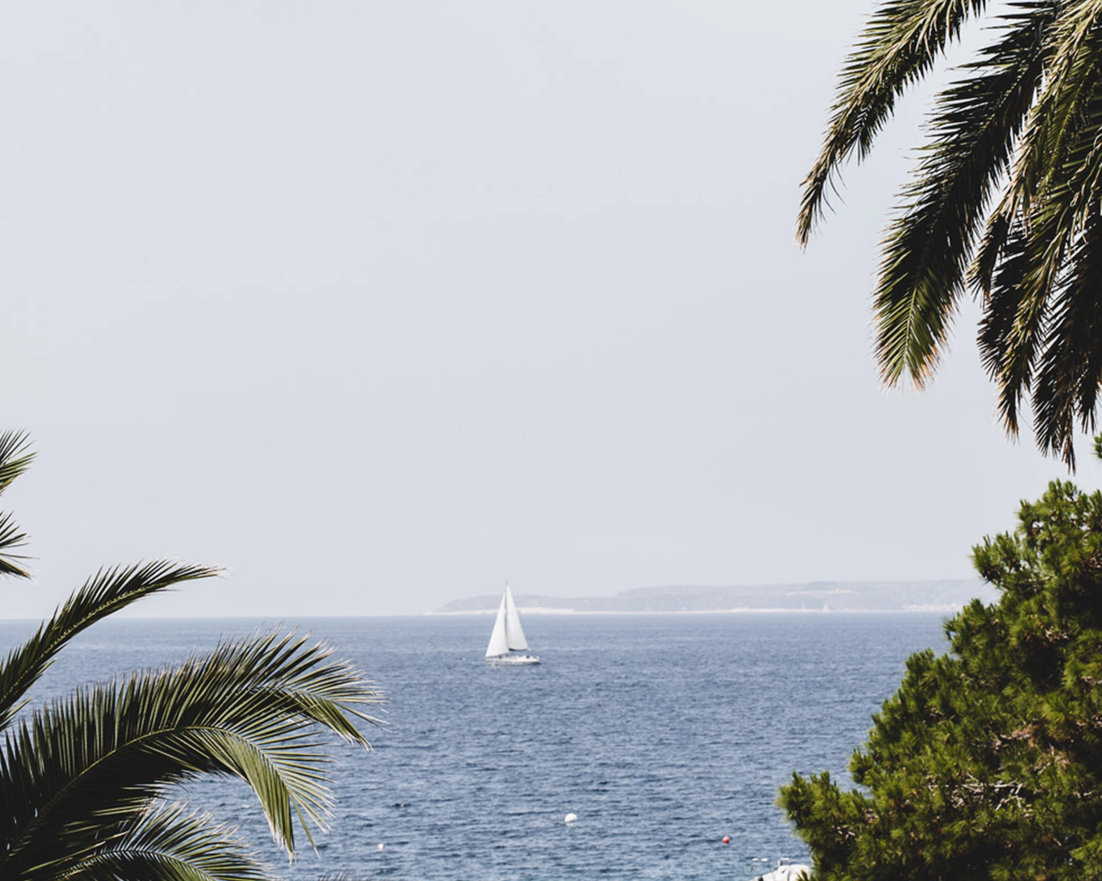 Sailing boat in the sea in the distance