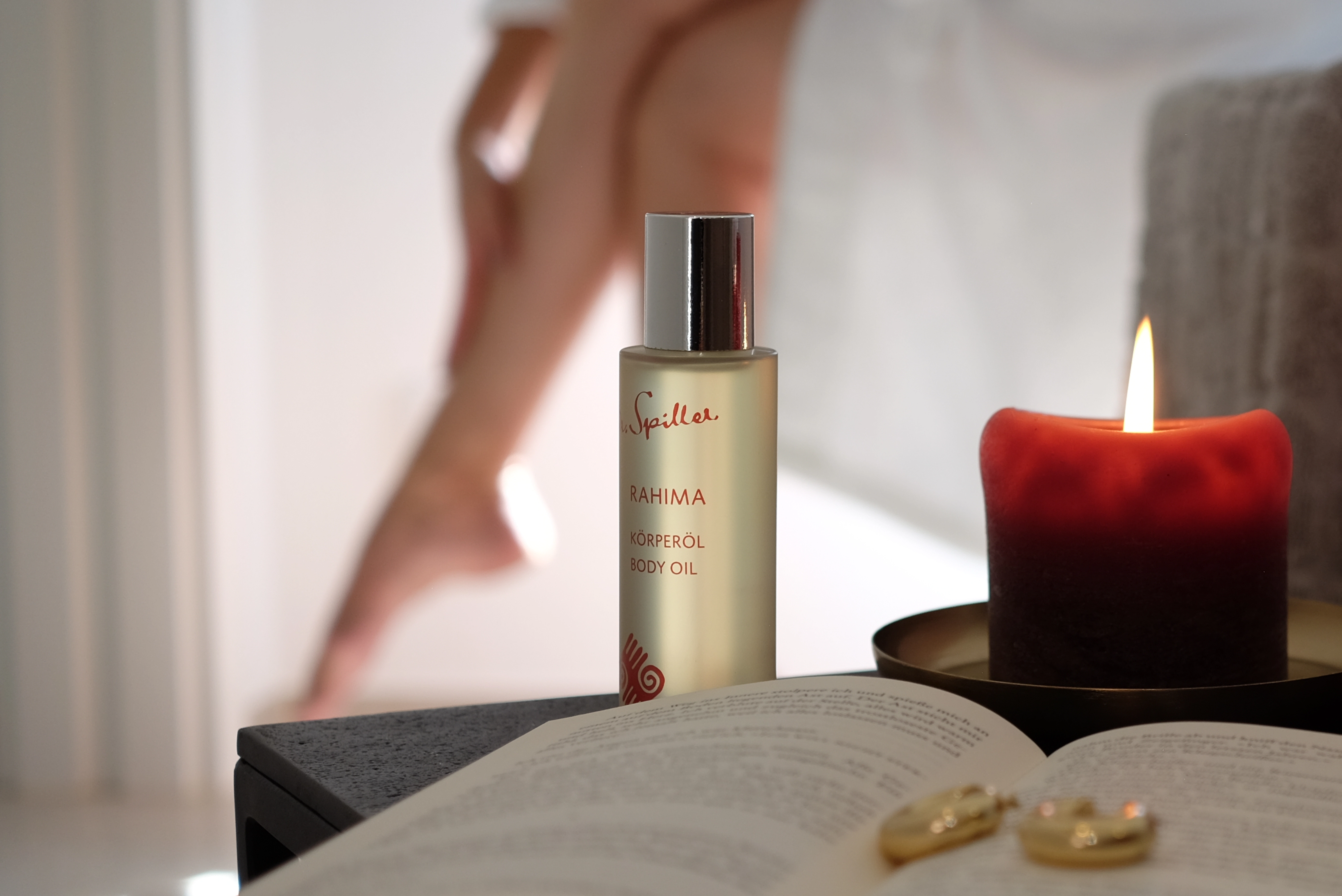 Rahima body oil with leg of woman in the background