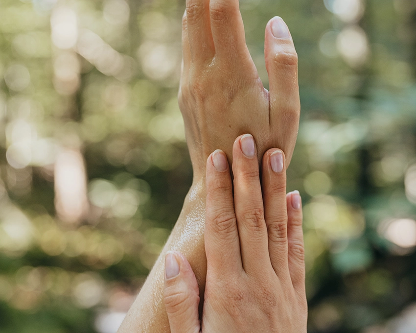 Gentle touch of two hands in nature outside