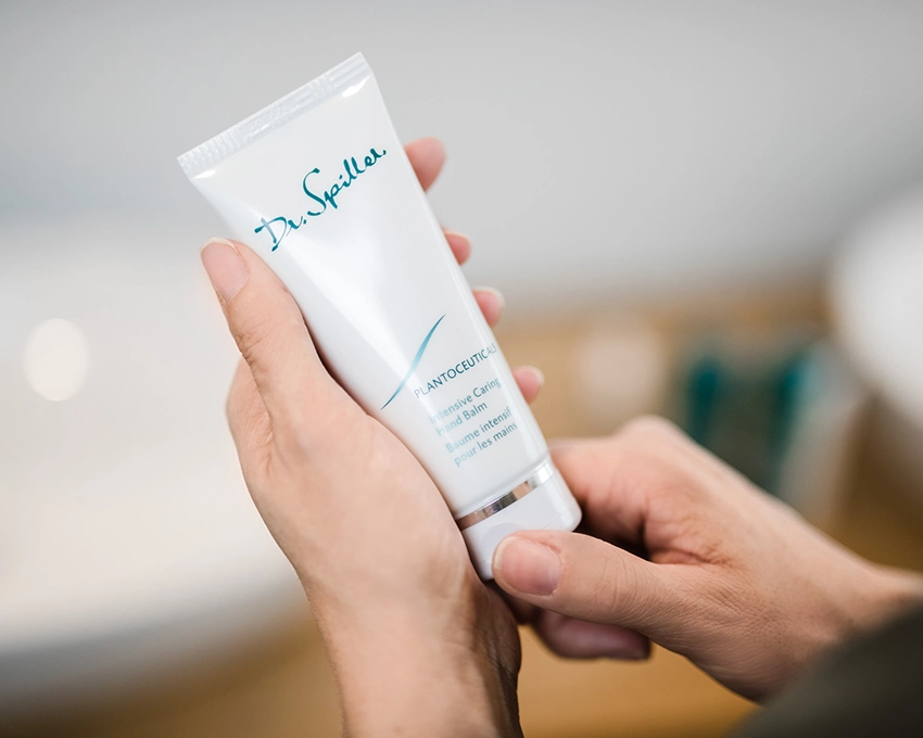 Dr. Spiller Intensive Caring Hand Balm tube held with two hands