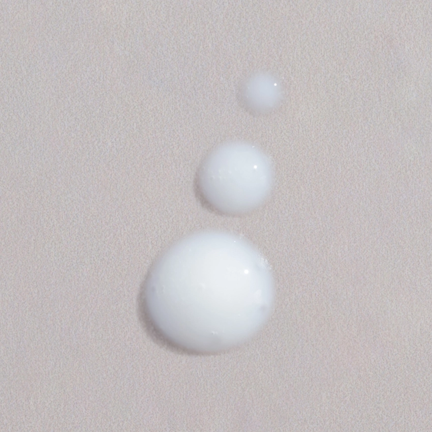 Close-up texture - several dots of a whitish-milky eye cream